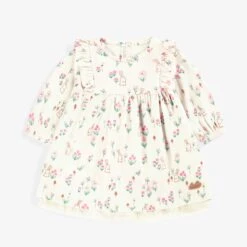 Robe Crème à Motifs, Naissance